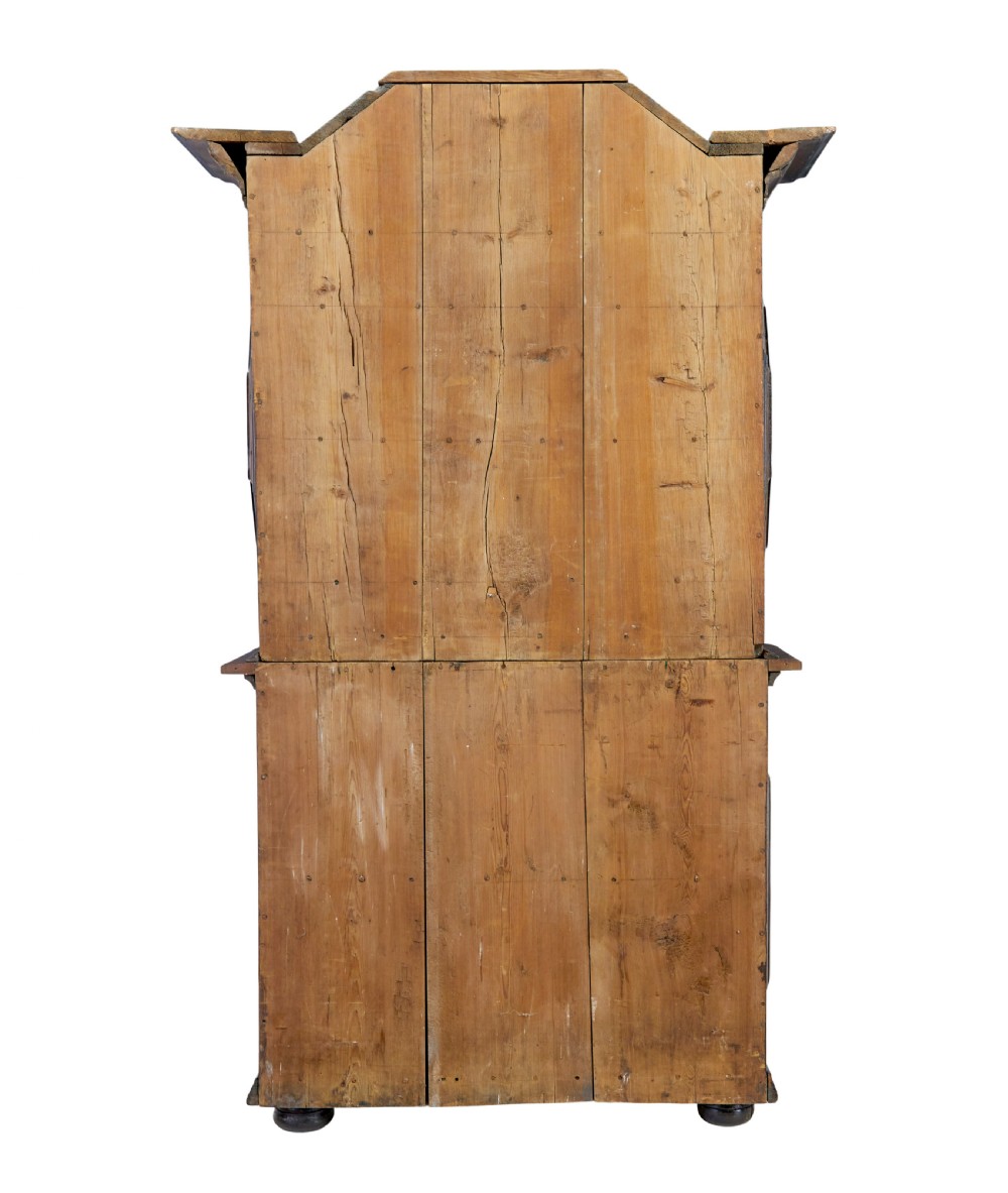 An 18th-century Scandinavian pine Baroque cupboard featuring faceted sides, geometric diamond mouldings on the upper doors, and a projected corniced top. View IV