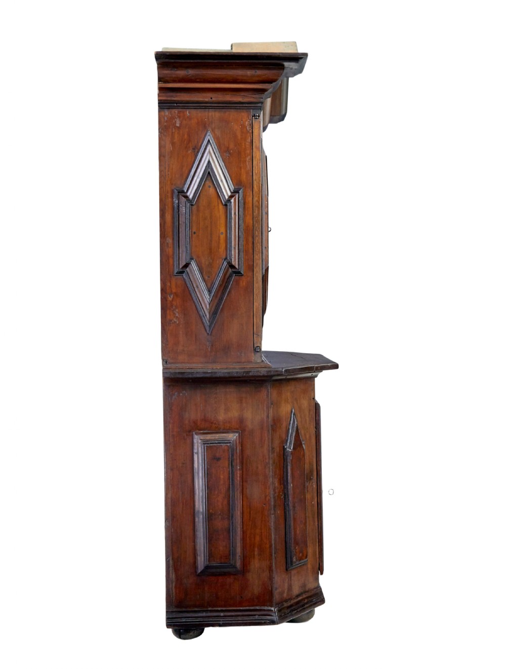 An 18th-century Scandinavian pine Baroque cupboard featuring faceted sides, geometric diamond mouldings on the upper doors, and a projected corniced top. View V
