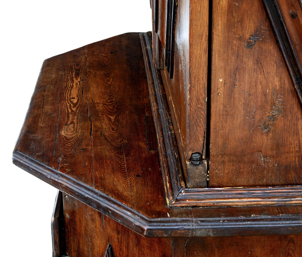 An 18th-century Scandinavian pine Baroque cupboard featuring faceted sides, geometric diamond mouldings on the upper doors, and a projected corniced top. View VII