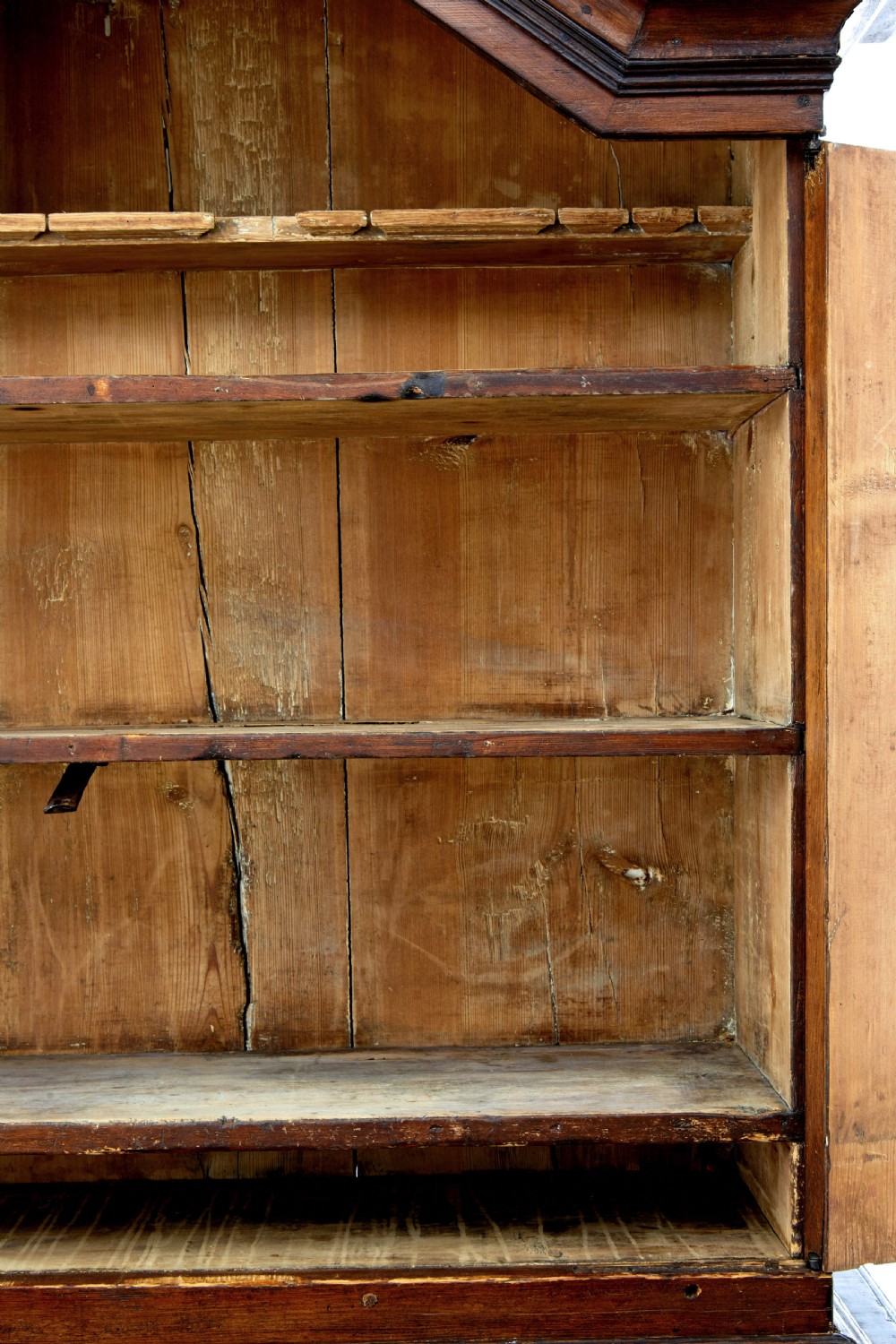 An 18th-century Scandinavian pine Baroque cupboard featuring faceted sides, geometric diamond mouldings on the upper doors, and a projected corniced top. View IX