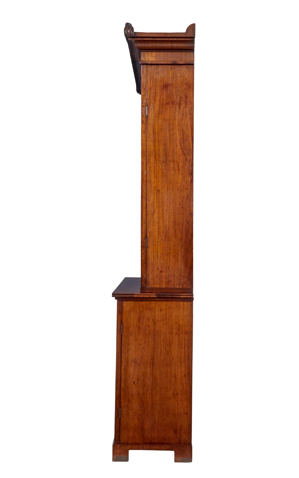 An early 19th-century flame mahogany bookcase featuring a pediment top, two upper glazed doors with arched astragal glazing, and a double-door cupboard base. View III