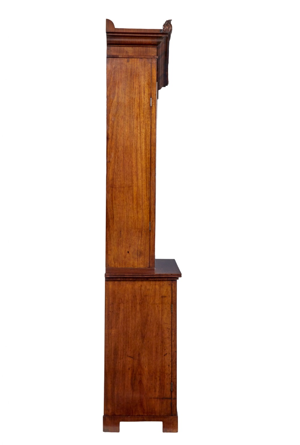 An early 19th-century flame mahogany bookcase featuring a pediment top, two upper glazed doors with arched astragal glazing, and a double-door cupboard base. View VI