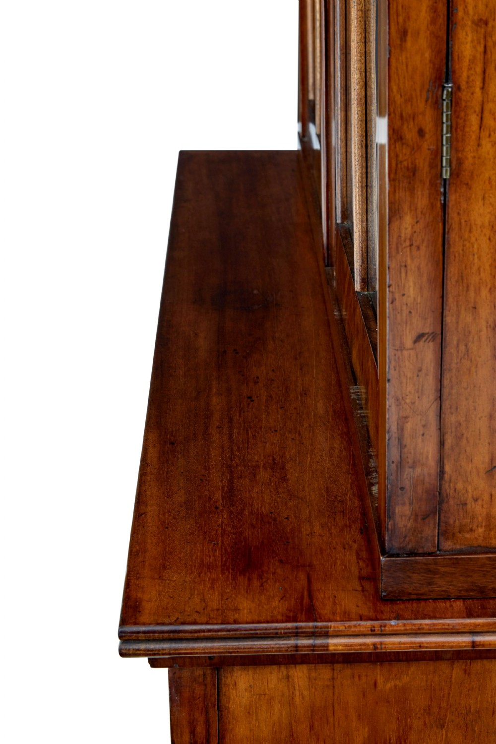 An early 19th-century flame mahogany bookcase featuring a pediment top, two upper glazed doors with arched astragal glazing, and a double-door cupboard base. View IX