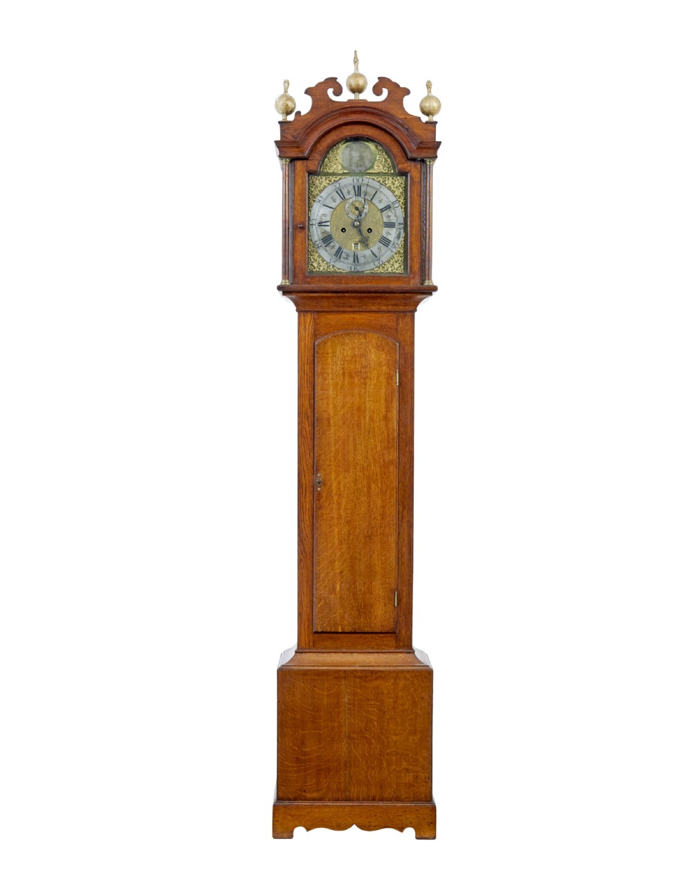 An 18th-century oak longcase clock featuring a brass dial, pediment hood with brass finials, rectangular trunk door, and plinth base.