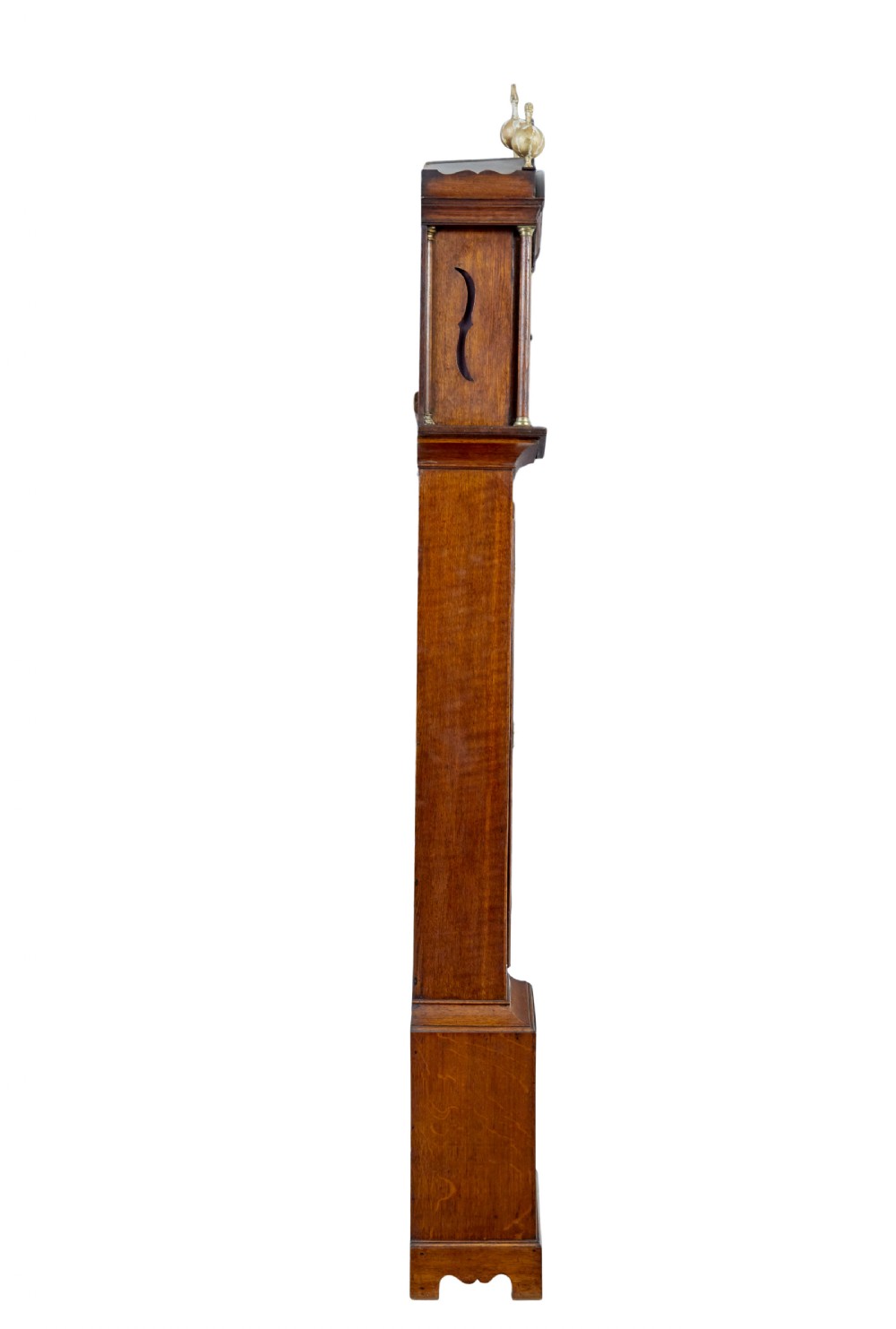 An 18th-century oak longcase clock featuring a brass dial, pediment hood with brass finials, rectangular trunk door, and plinth base. View V