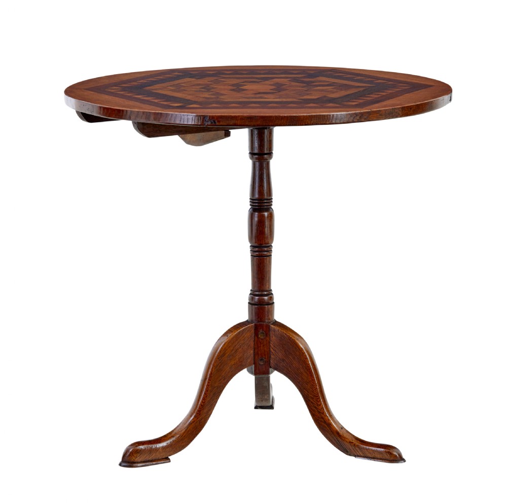 A 19th-century round oak occasional table featuring a geometric inlaid wood top, a turned central pedestal, and three splayed legs. View II