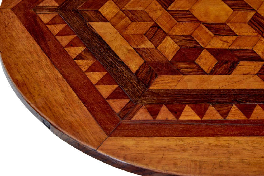 A 19th-century round oak occasional table featuring a geometric inlaid wood top, a turned central pedestal, and three splayed legs. View VI