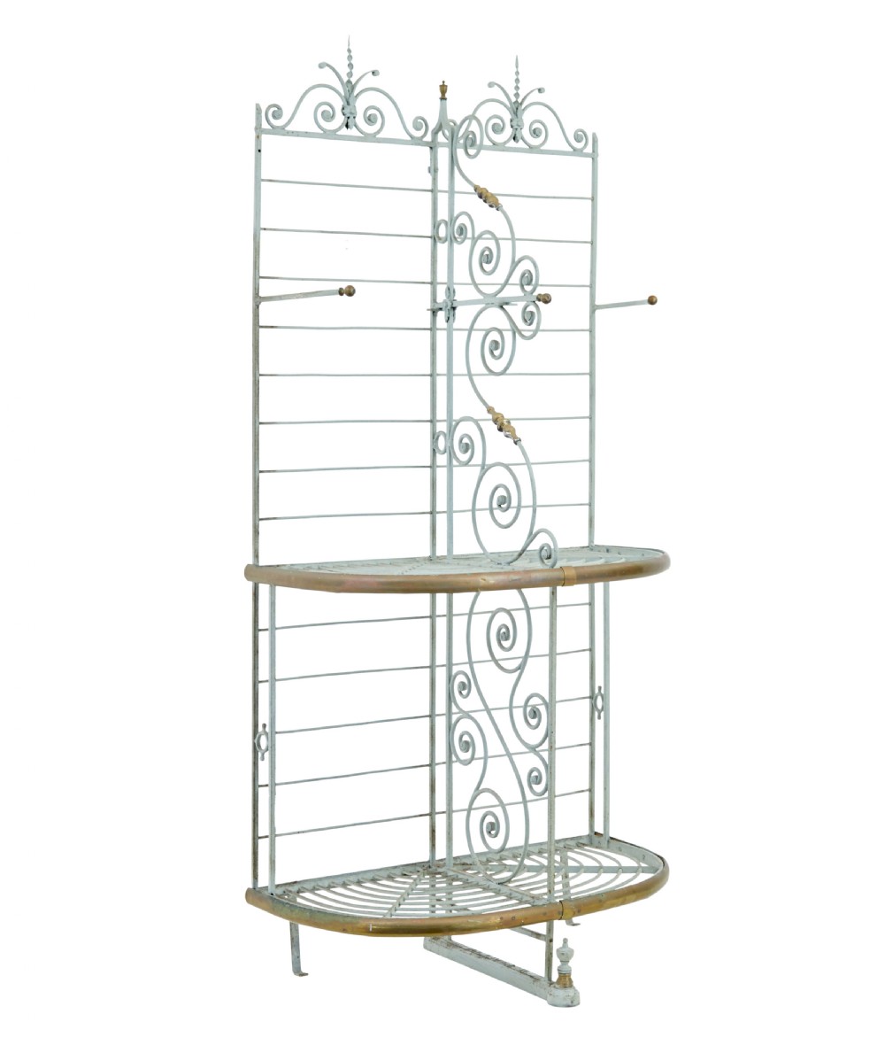 An early twentieth-century French pale blue painted wrought iron bakers rack with decorative scrollwork cresting and brass edging.