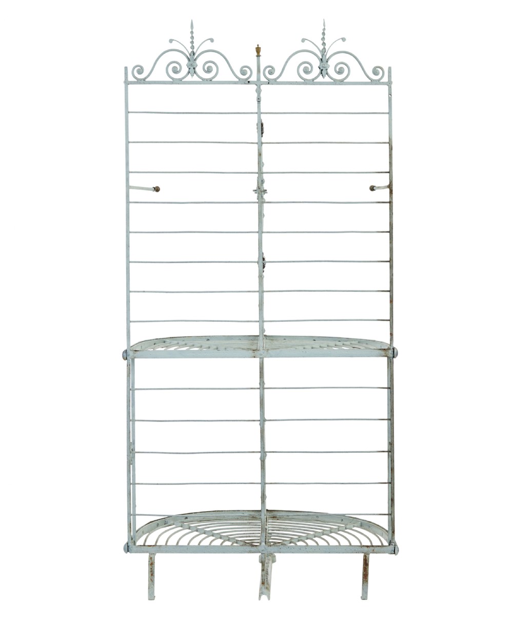 An early twentieth-century French pale blue painted wrought iron bakers rack with decorative scrollwork cresting and brass edging. View II