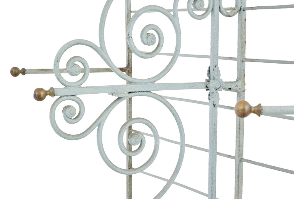 An early twentieth-century French pale blue painted wrought iron bakers rack with decorative scrollwork cresting and brass edging. View IV