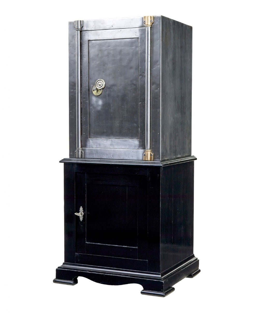 A 19th-century Danish polished steel safe with brass details mounted on a black painted wooden cabinet base.