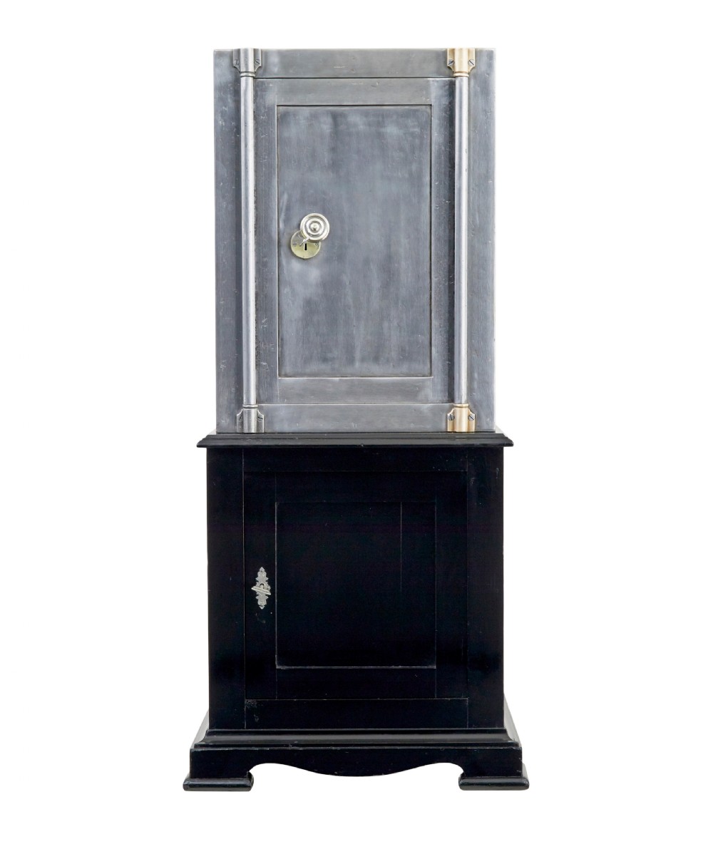 A 19th-century Danish polished steel safe with brass details mounted on a black painted wooden cabinet base. View II