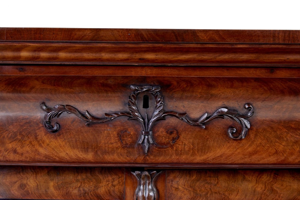 A mid-19th century Danish mahogany bookcase featuring a glazed upper display cabinet and lower doors with elaborate relief carvings. View II