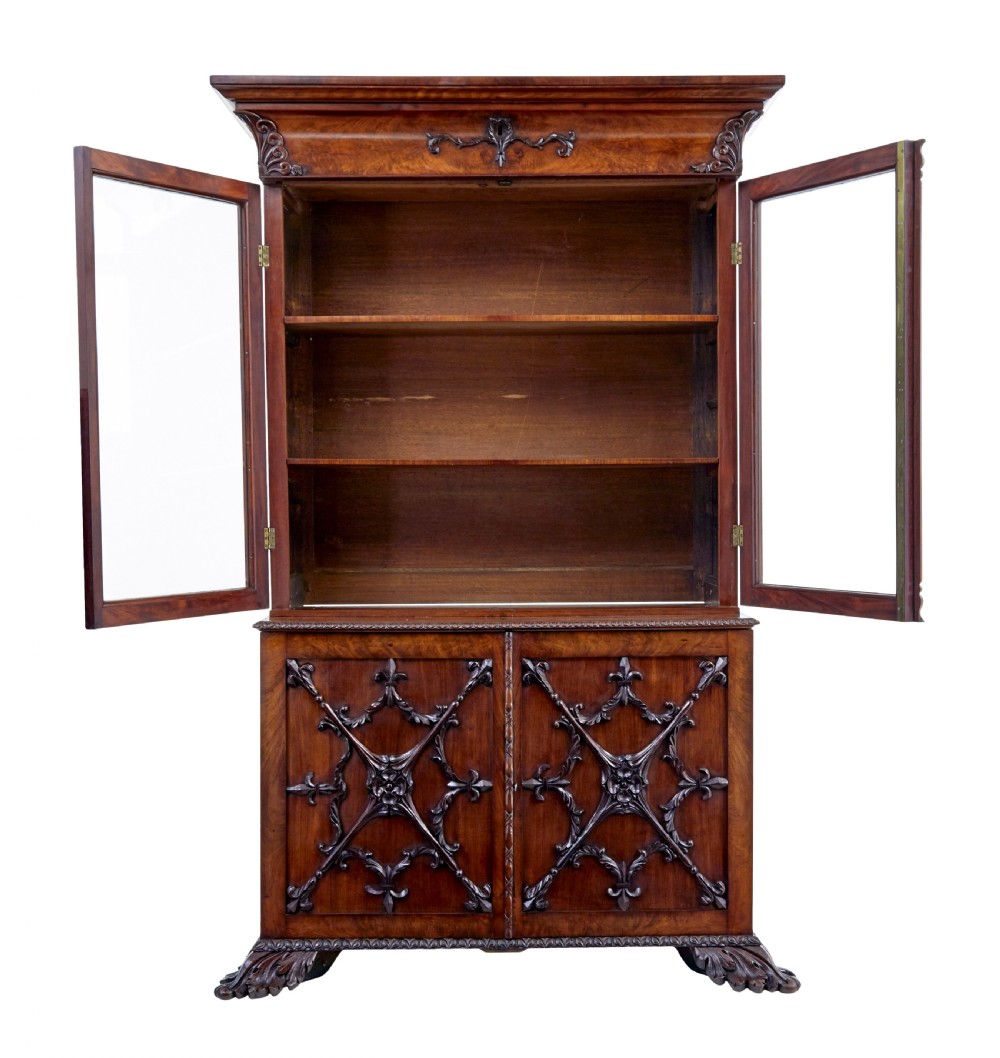 A mid-19th century Danish mahogany bookcase featuring a glazed upper display cabinet and lower doors with elaborate relief carvings. View V