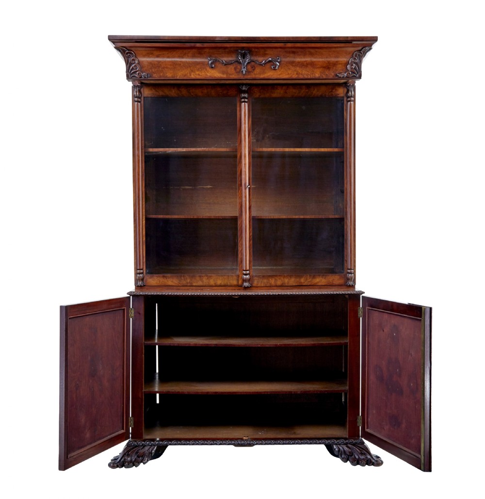 A mid-19th century Danish mahogany bookcase featuring a glazed upper display cabinet and lower doors with elaborate relief carvings. View VI
