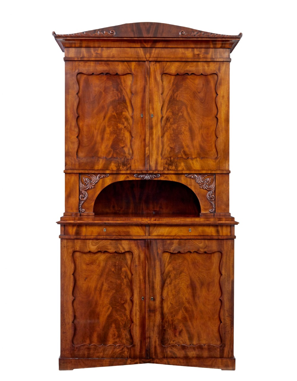 A mid-19th-century Danish flame mahogany tall cabinet featuring a carved cresting pediment, open central niche, and double cupboard doors with moulded panels.