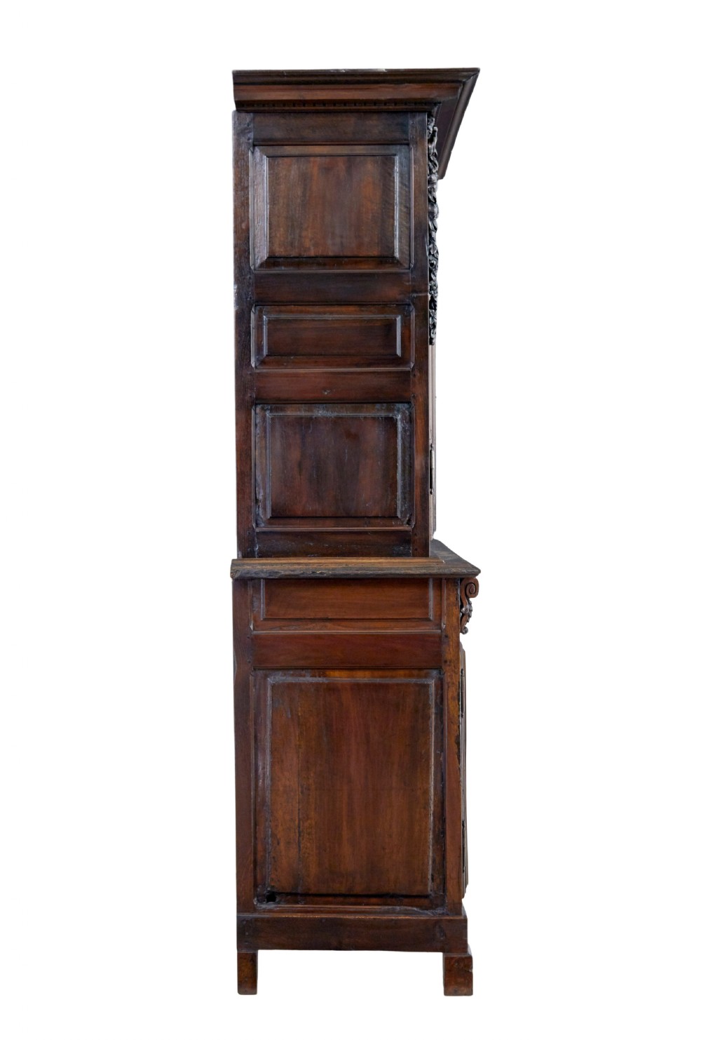 An eighteenth-century French carved walnut cupboard in two tiers featuring geometric relief panels, floral motifs, cherub carvings, and decorative steel hinges. View V