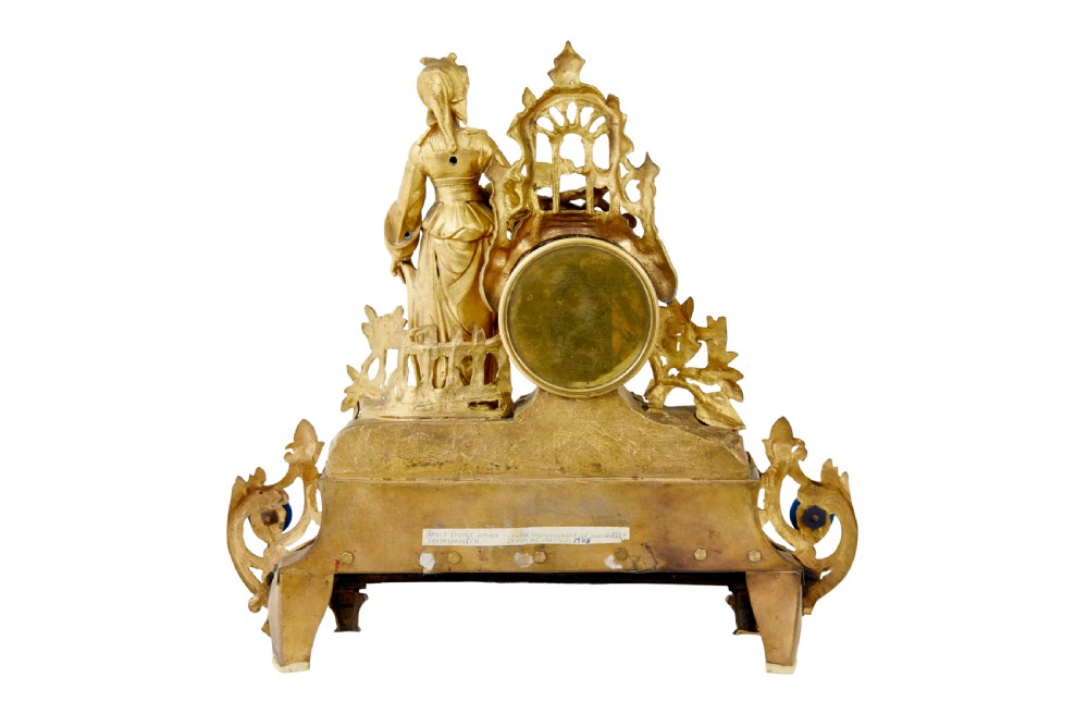 An ornate 19th-century French gilt metal mantel clock featuring a sculpted female figure, Rococo scrollwork, and hand-painted turquoise blue porcelain plaques. View III