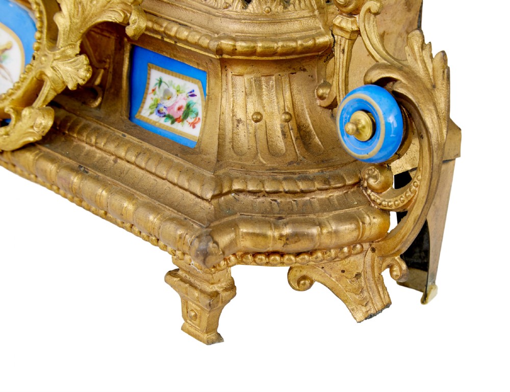 An ornate 19th-century French gilt metal mantel clock featuring a sculpted female figure, Rococo scrollwork, and hand-painted turquoise blue porcelain plaques. View V