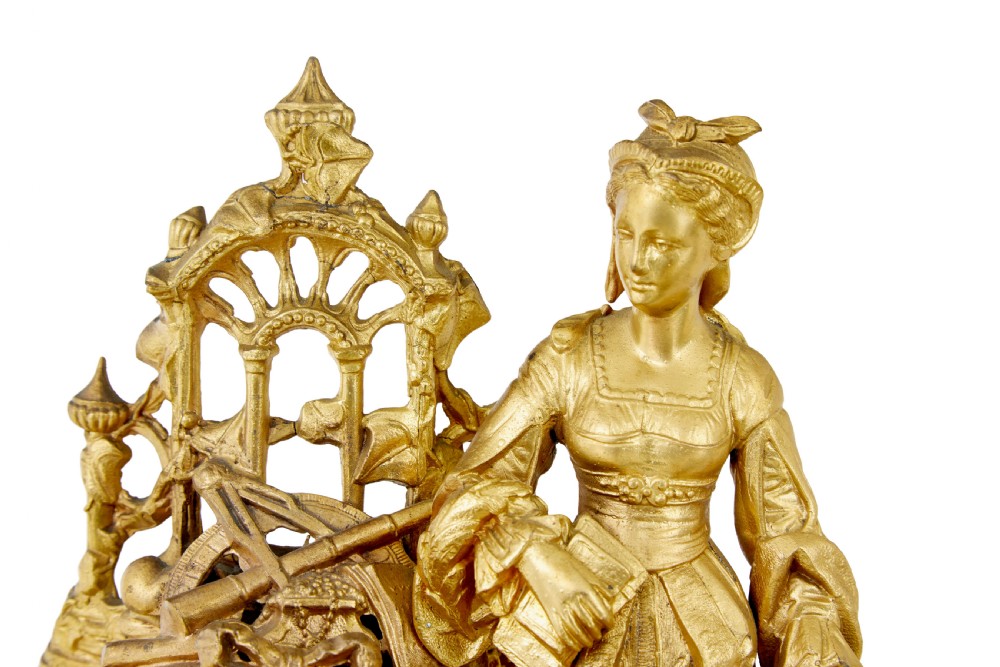 An ornate 19th-century French gilt metal mantel clock featuring a sculpted female figure, Rococo scrollwork, and hand-painted turquoise blue porcelain plaques. View VIII