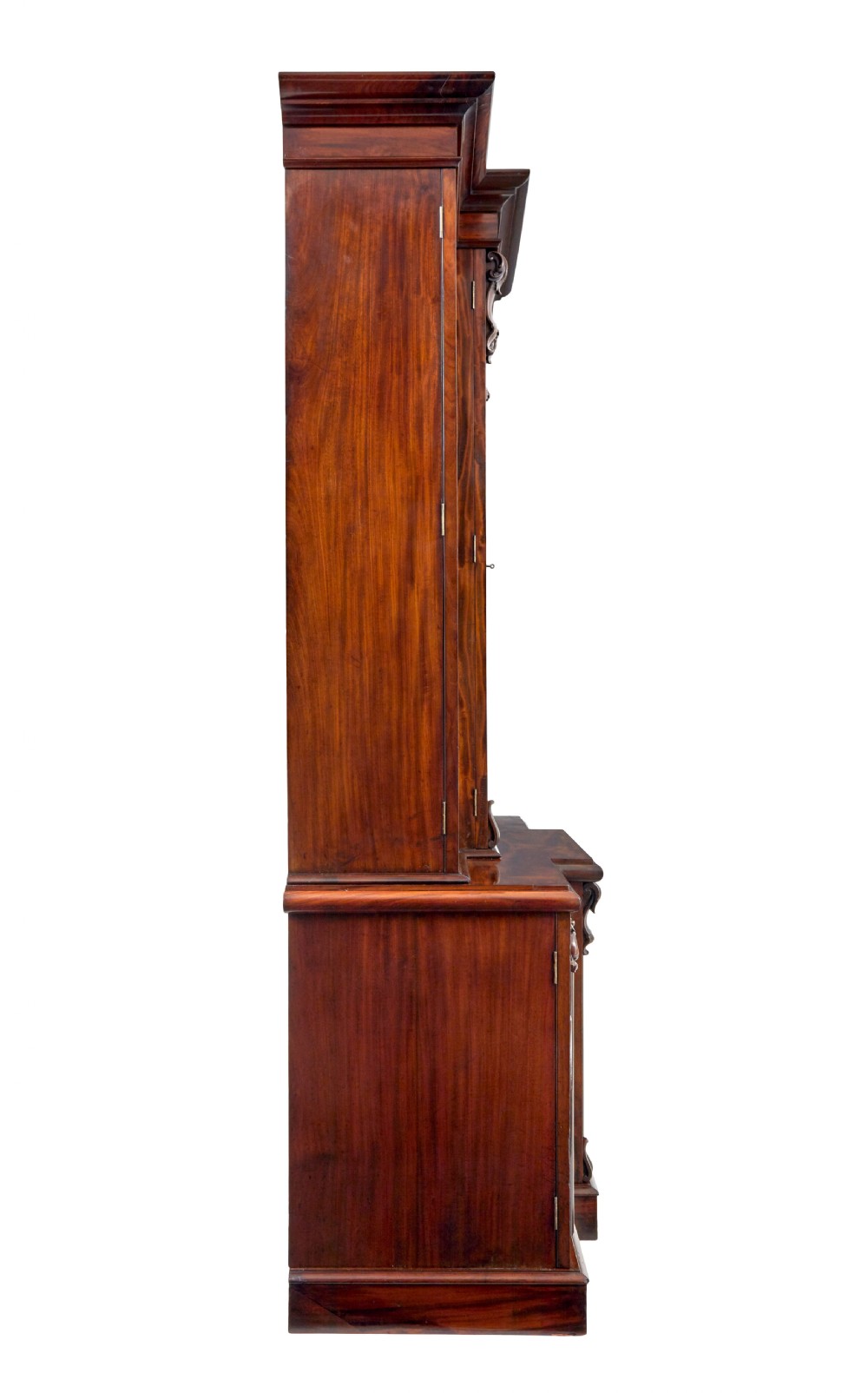 A large early Victorian flame mahogany breakfront bookcase featuring glazed upper doors and panelled lower cupboard doors. View VI