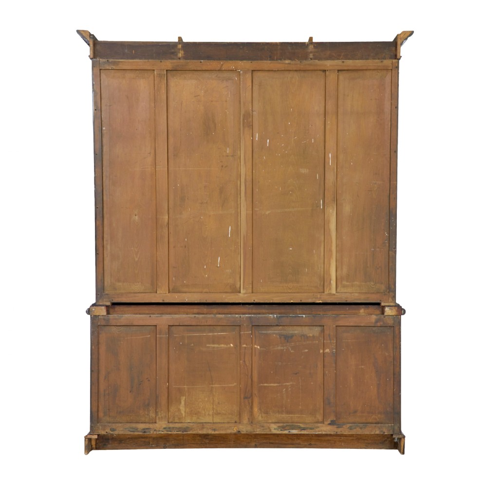 A large early Victorian flame mahogany breakfront bookcase featuring glazed upper doors and panelled lower cupboard doors. View VII
