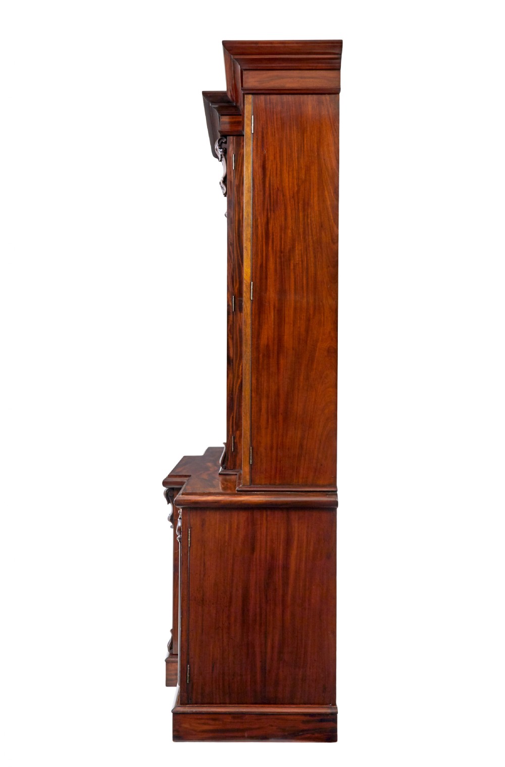 A large early Victorian flame mahogany breakfront bookcase featuring glazed upper doors and panelled lower cupboard doors. View VIII