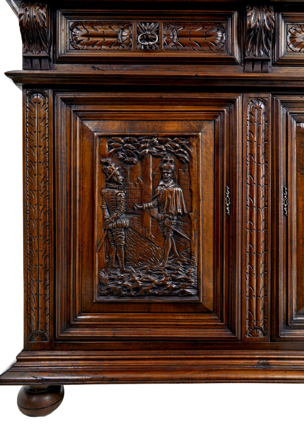 Mid 19th century dark walnut two-tiered Italian cabinet featuring intricately carved relief panels of figures, decorative drawers, and bun feet. View IX