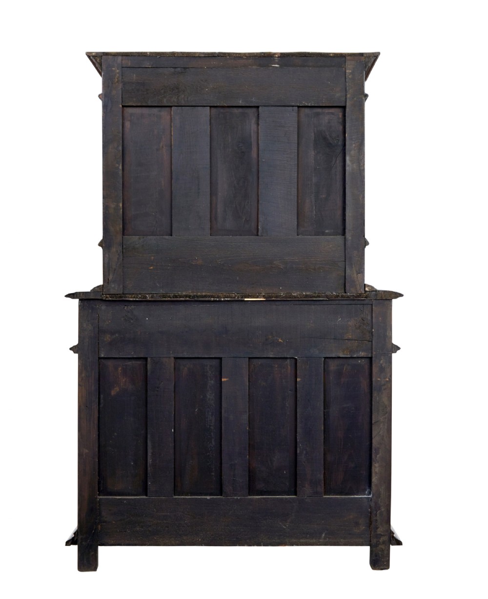 Mid 19th century dark walnut two-tiered Italian cabinet featuring intricately carved relief panels of figures, decorative drawers, and bun feet. View XI