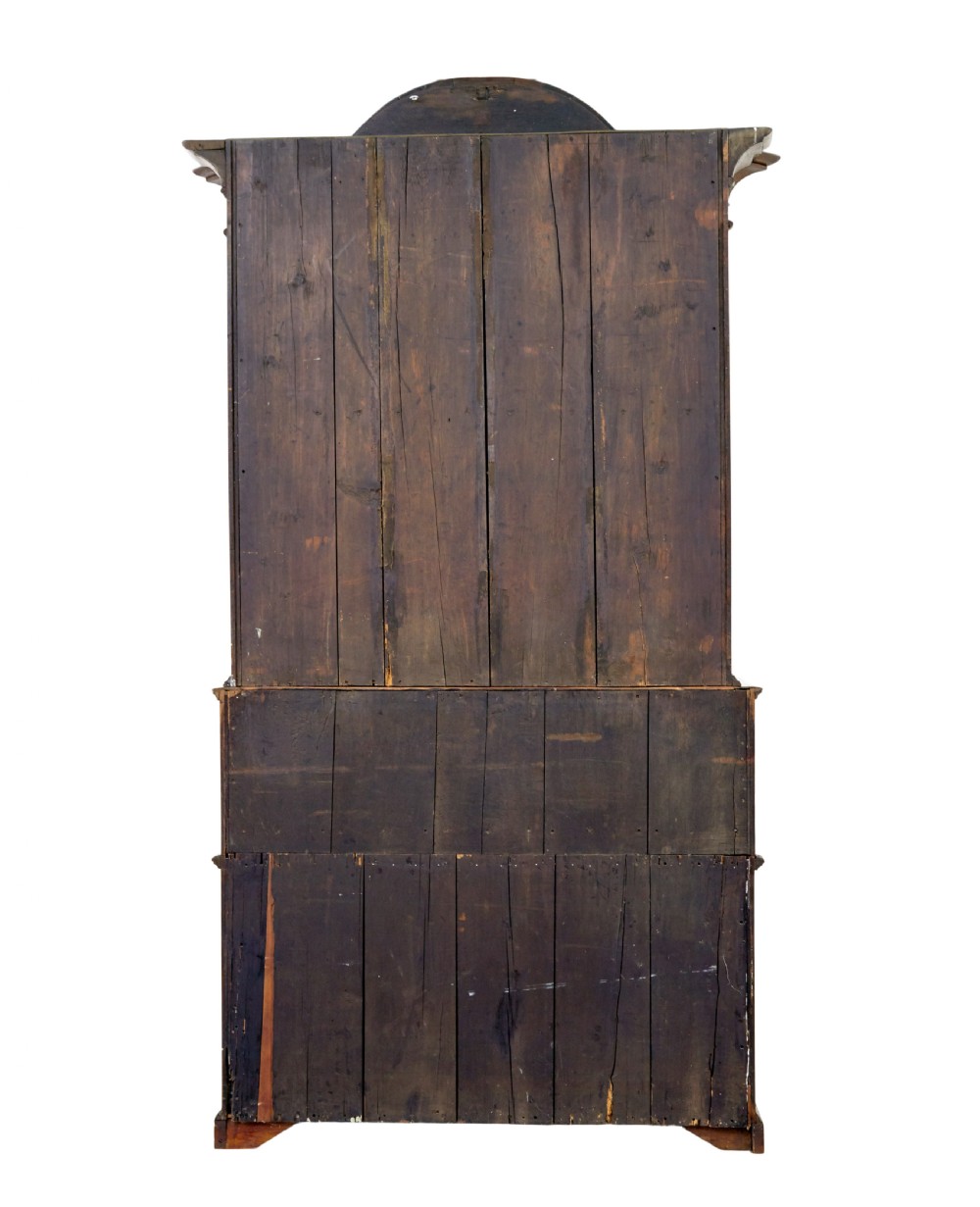 An 18th-century Norwegian carved oak bureau bookcase featuring an arched pediment, panelled upper doors, a slant-front writing slant, serpentine lower drawers, and brass escutcheons. View VIII