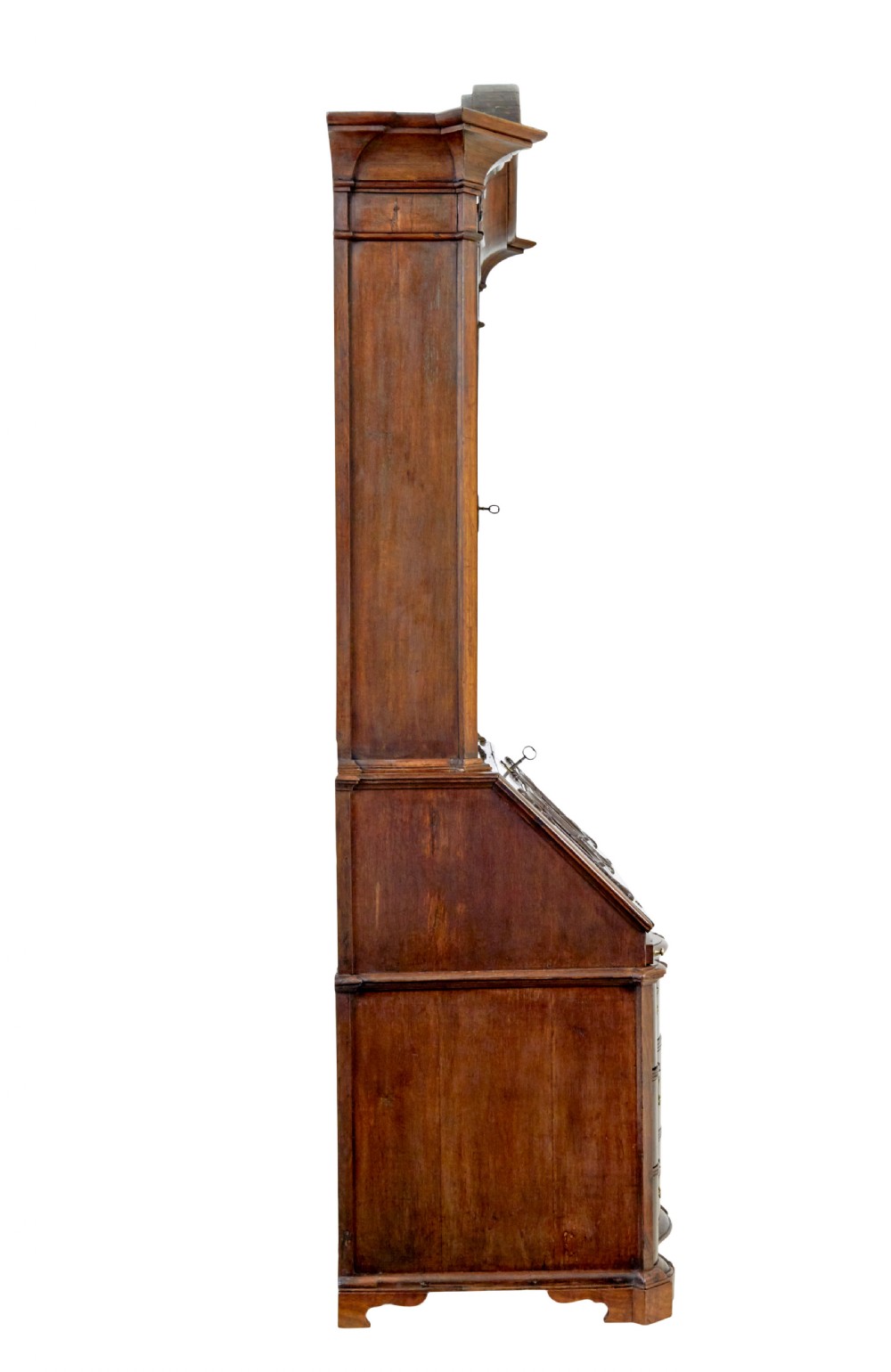 An 18th-century Norwegian carved oak bureau bookcase featuring an arched pediment, panelled upper doors, a slant-front writing slant, serpentine lower drawers, and brass escutcheons. View IX
