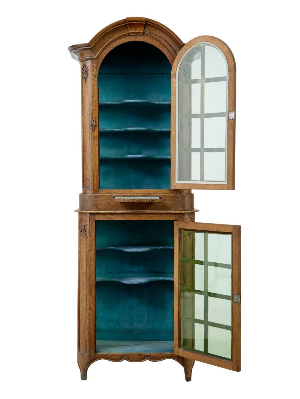 A mid-19th-century carved oak display cabinet featuring glazed doors, arched pediment, and green fabric interior lining. View III