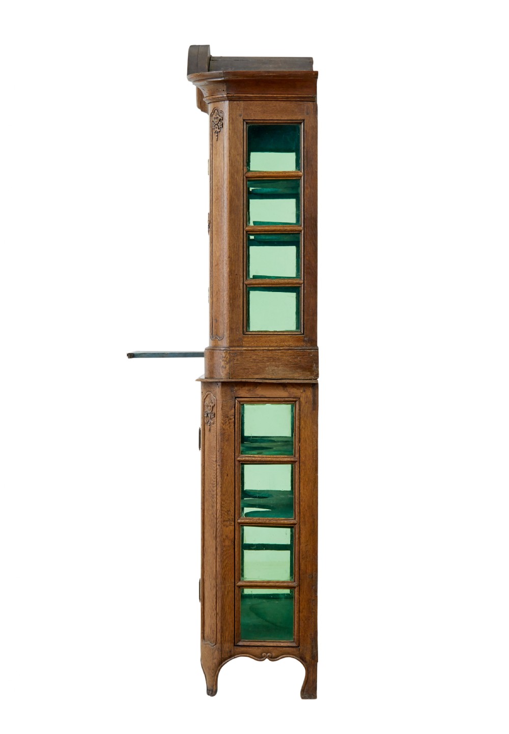 A mid-19th-century carved oak display cabinet featuring glazed doors, arched pediment, and green fabric interior lining. View V