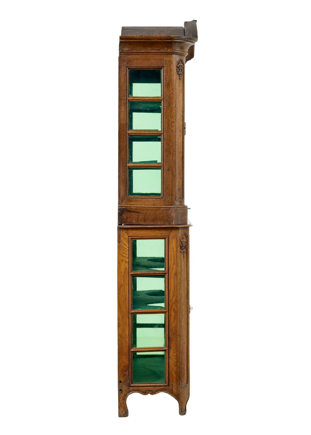 A mid-19th-century carved oak display cabinet featuring glazed doors, arched pediment, and green fabric interior lining. View VI