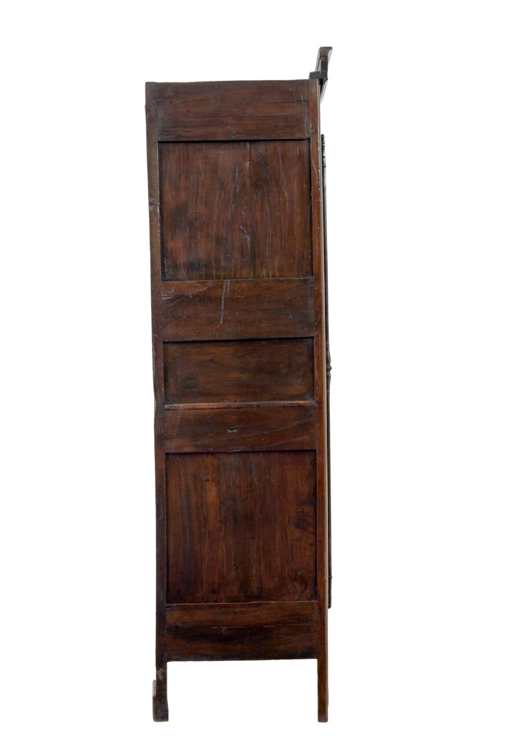 An 18th-century French armoire in warm brown yew and chestnut wood featuring carved foliate inlay, arched panel doors, and long iron escutcheons. View IV