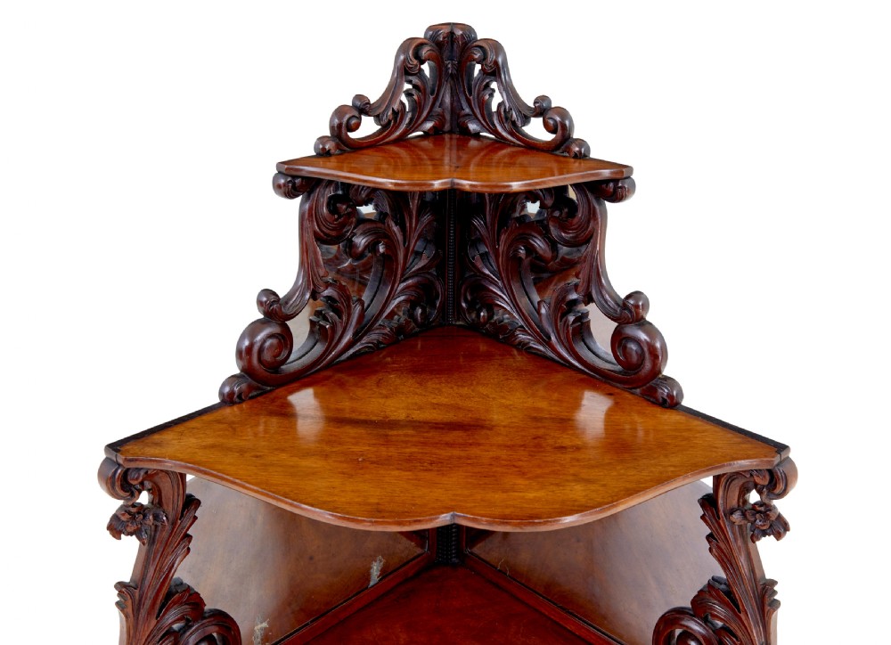 A nineteenth-century Victorian carved mahogany corner whatnot featuring open tiered triangular shelves, mirrored back panels, and ornate scrollwork supports. View II