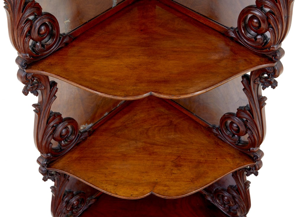 A nineteenth-century Victorian carved mahogany corner whatnot featuring open tiered triangular shelves, mirrored back panels, and ornate scrollwork supports. View III