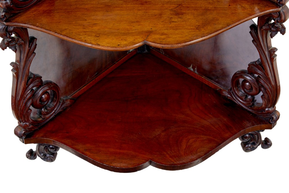 A nineteenth-century Victorian carved mahogany corner whatnot featuring open tiered triangular shelves, mirrored back panels, and ornate scrollwork supports. View IV