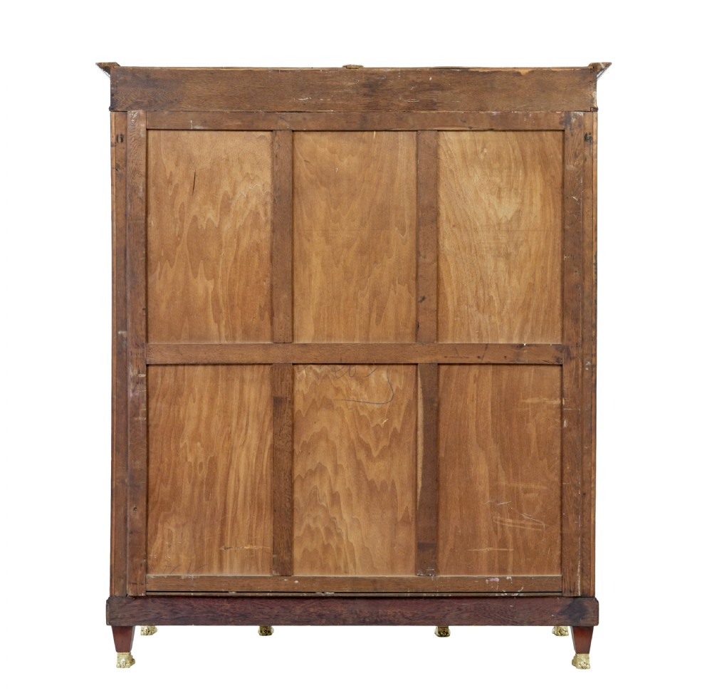 A late nineteenth-century French Empire style mahogany cabinet featuring three doors, central glass panelling, and ornate gold-coloured ormolu mounts. View V