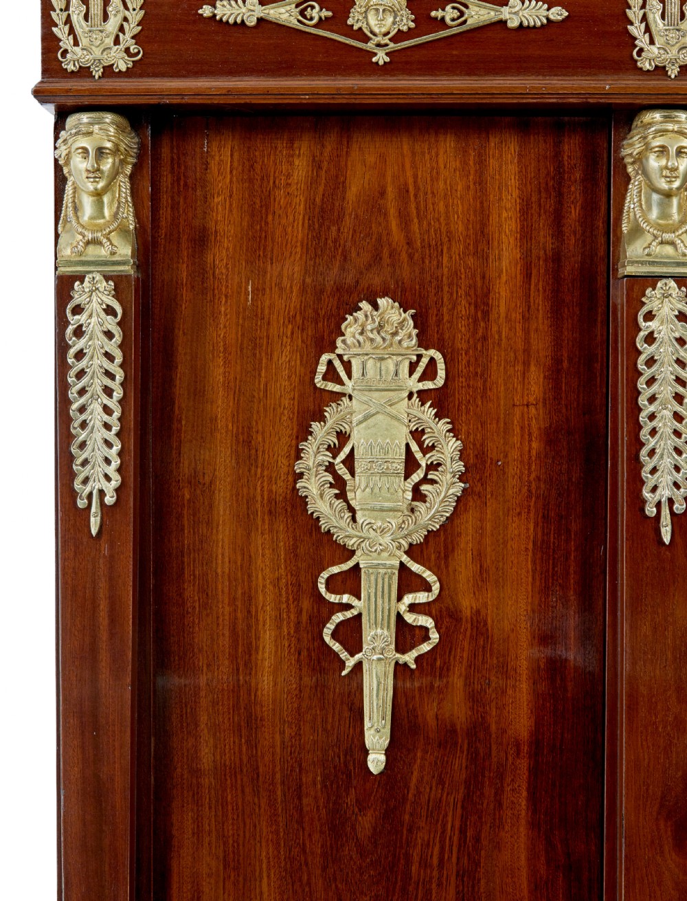 A late nineteenth-century French Empire style mahogany cabinet featuring three doors, central glass panelling, and ornate gold-coloured ormolu mounts. View VIII
