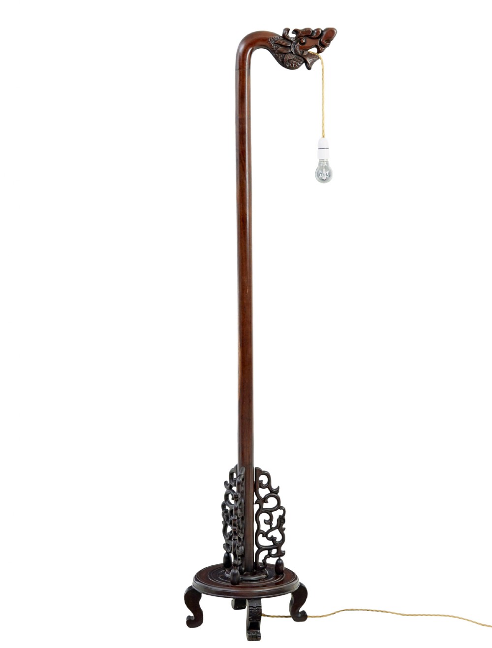 A tall dark hardwood floor lamp featuring a carved dragon head top motif and an openwork carved base with cabriole feet. View V