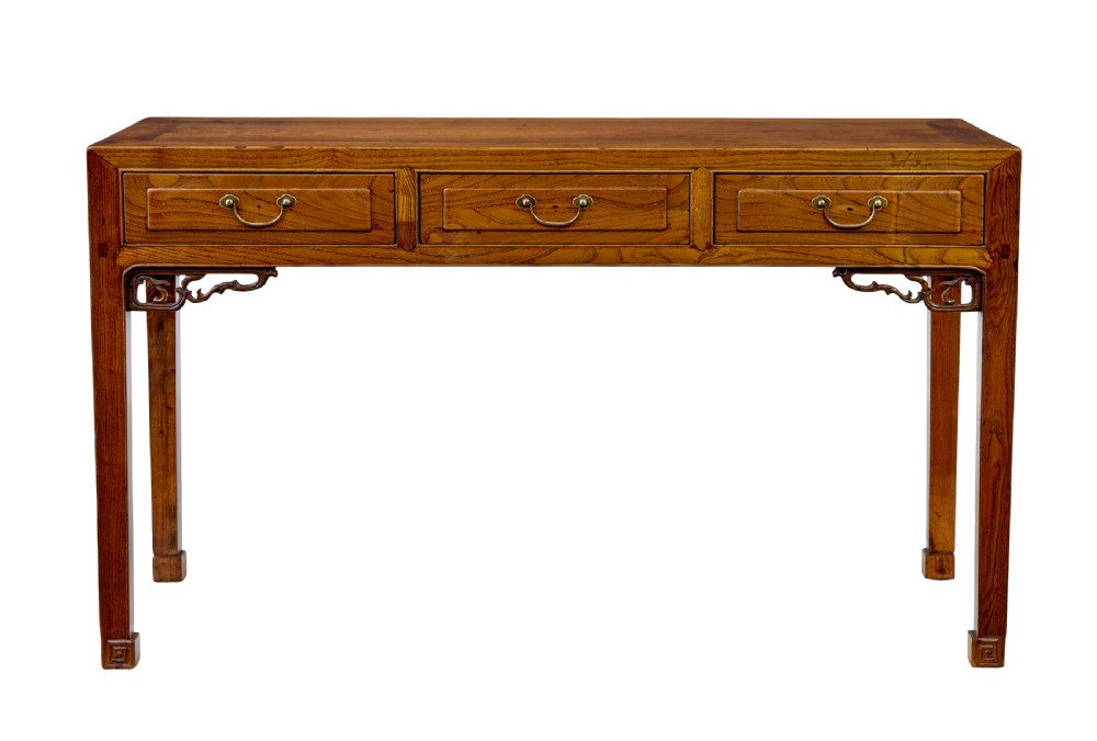 A 19th-century Chinese carved elm console table featuring three drawers with brass handles, carved corner spandrels, and square legs. View III