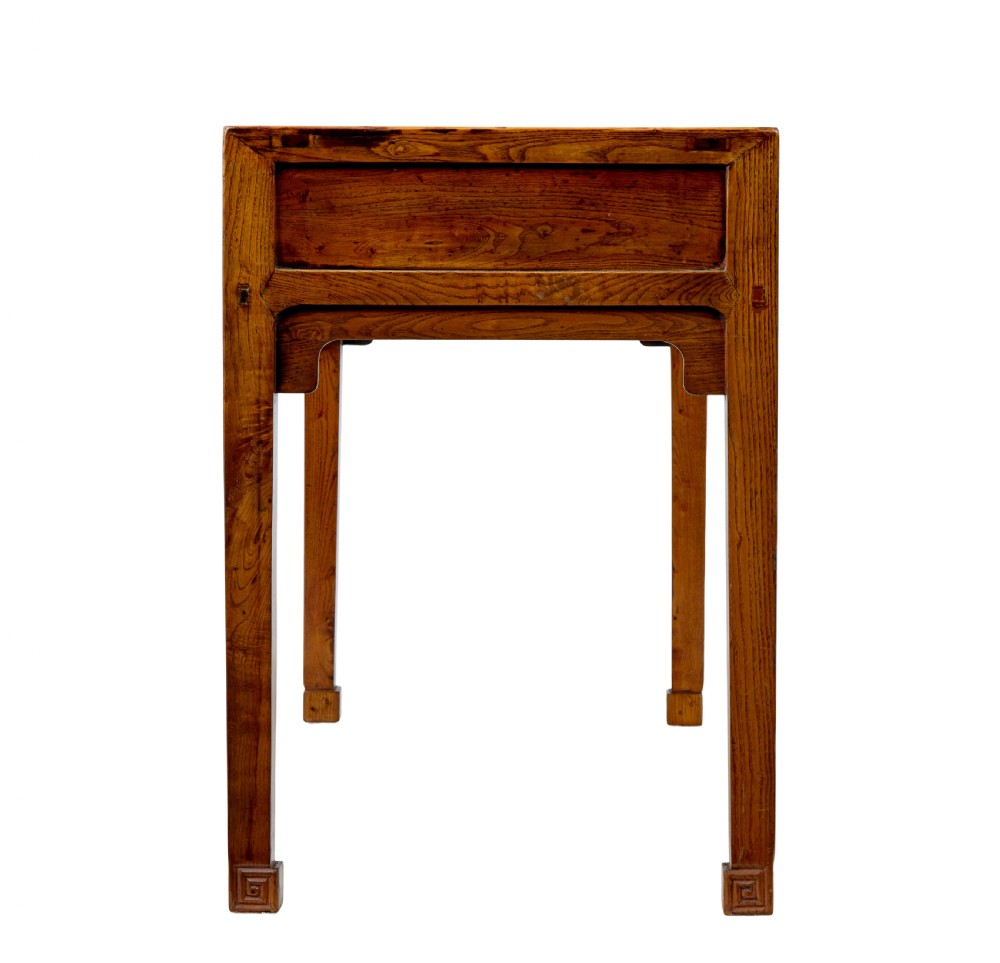 A 19th-century Chinese carved elm console table featuring three drawers with brass handles, carved corner spandrels, and square legs. View IV