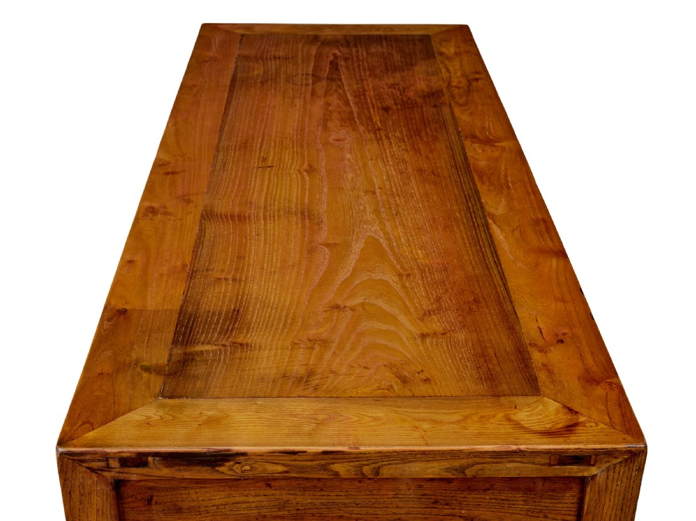 A 19th-century Chinese carved elm console table featuring three drawers with brass handles, carved corner spandrels, and square legs. View IX