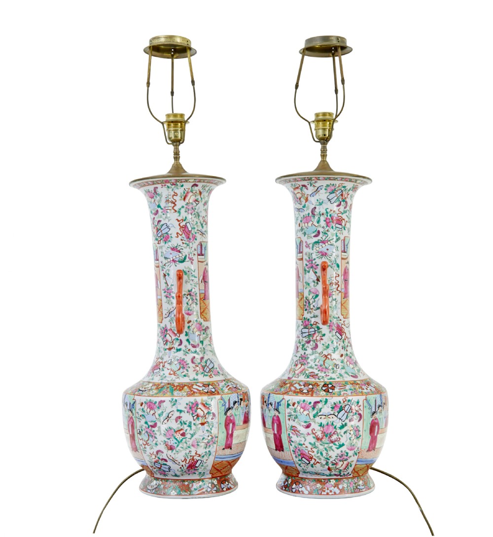 A pair of large early 20th-century Chinese Cantonese porcelain vase lamps featuring hand-painted figurative panels, scroll handles, and brass light fittings. View III