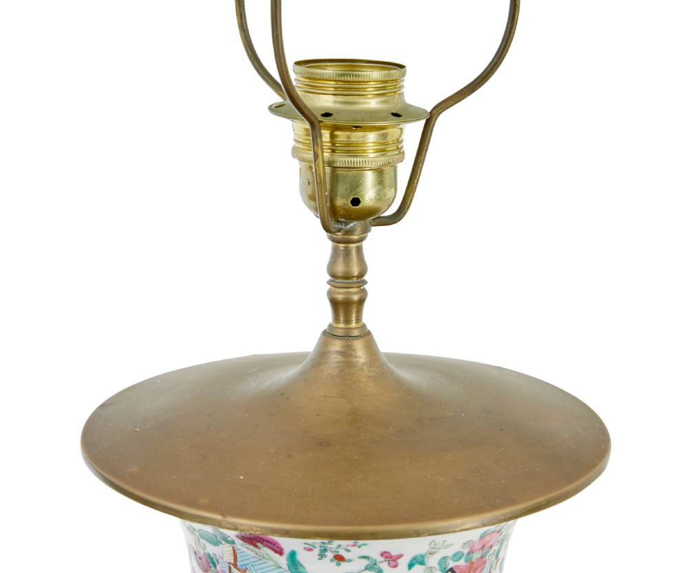 A pair of large early 20th-century Chinese Cantonese porcelain vase lamps featuring hand-painted figurative panels, scroll handles, and brass light fittings. View V
