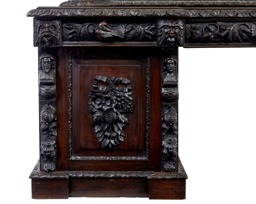 A 19th-century dark oak sideboard featuring twin carved pedestal cupboards, relief fruit swags, and an upper mirrored frame superstructure. View III