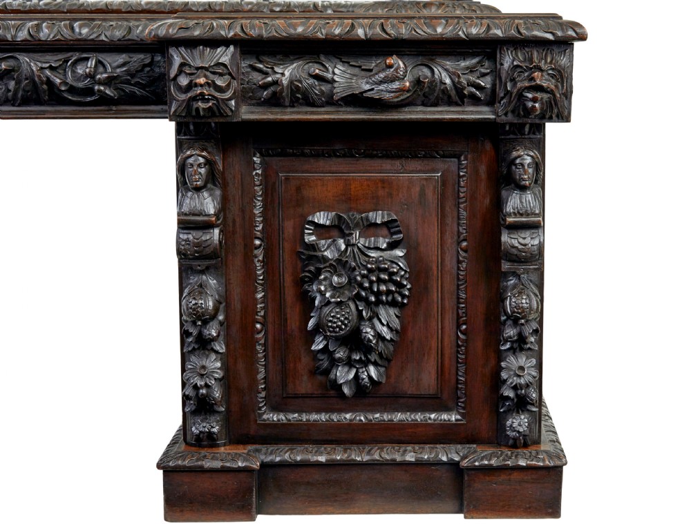 A 19th-century dark oak sideboard featuring twin carved pedestal cupboards, relief fruit swags, and an upper mirrored frame superstructure. View V