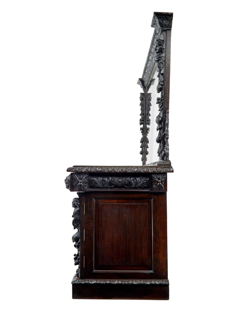 A 19th-century dark oak sideboard featuring twin carved pedestal cupboards, relief fruit swags, and an upper mirrored frame superstructure. View VI