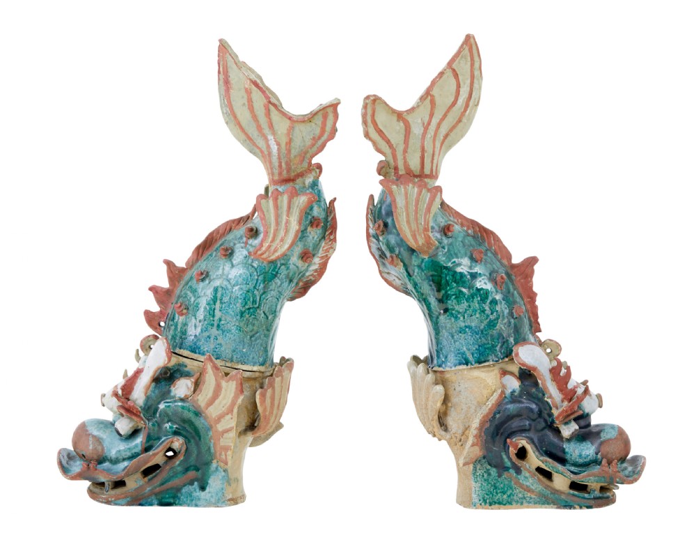 A pair of 19th-century Japanese glazed ceramic Shachihoko roof ornaments depicting dragon-headed carp with raised tails in green, red, and cream glazes. View II